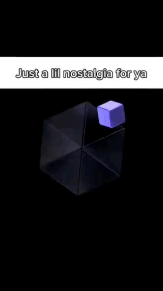 The image features a black background with a transparent, three-dimensional geometric frame (resembling an empty cube outline) positioned centrally. Above this frame floats a smaller, solid purple cube. At the top of the image, white text reads 'Just a lil nostalgia for ya'. The simple design evokes a sense of nostalgia, likely referencing childhood toys, early 3D graphics, or minimalist visual aesthetics from past decades.