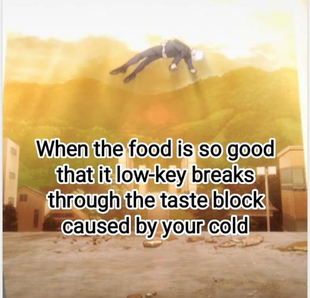 An animated meme featuring a white-haired character in a suit floating dramatically against a backdrop of a destroyed area with buildings and debris. The text overlay humorously states, 'When the food is so good that it low-key breaks through the taste block caused by your cold,' exaggerating the experience of exceptionally delicious food overcoming the reduced sense of taste from a cold.