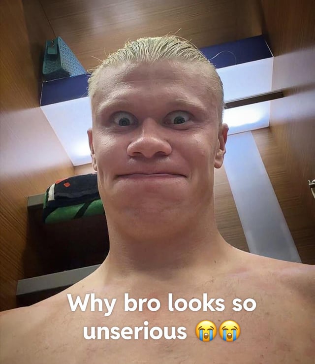 This meme features a close-up shirtless selfie of professional Norwegian footballer Erling Haaland making an intentionally goofy, cross-eyed expression with his lips pursed, filmed in what appears to be a locker room with ceiling lights and storage shelves in the background. White overlaid text at the bottom reads 'Why bro looks so unserious' followed by two crying laughing face emojis, joking about how uncharacteristically playful and silly Haaland looks compared to his serious, intense public persona during football matches.