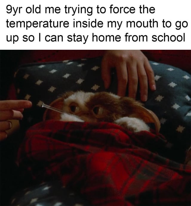 The meme consists of a top text caption and a screenshot from the 1984 movie 'Gremlins'. The caption reads: '9yr old me trying to force the temperature inside my mouth to go up so I can stay home from school'. The image features Gizmo, the small, furry, and iconic creature from 'Gremlins', lying under a red plaid blanket on a blue pillow adorned with white star patterns. A hand is visible holding a thermometer in Gizmo's mouth, and he displays a worried or anxious expression, as if attempting to fake a fever to avoid school, humorously mirroring the childhood experience described in the text.
