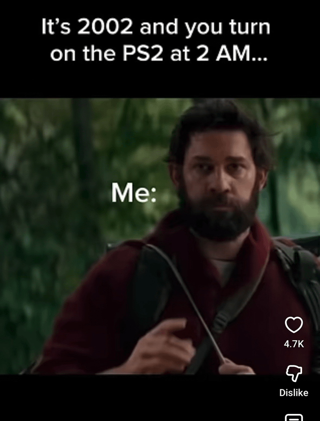 This is a relatable comedy nostalgia meme. The top of the image displays text reading 'It’s 2002 and you turn on the PS2 at 2 AM...', below which is a screenshot of the character Lee Abbott from the 2018 horror film *A Quiet Place* looking tense and alert, with the text 'Me:' placed next to him. The joke references the common 2000s experience of turning on a PlayStation 2 connected to a CRT television late at night: the device produced a very loud, distinct startup and static noise that would risk waking up other members of the household, putting the person turning on the console in the same high-stakes no-sound situation as the characters in *A Quiet Place*, where any loud sound attracts deadly monsters. TikTok interface elements are visible on the right edge of the screenshot.