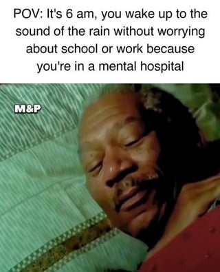 This is a dark humor meme composed of top text and a reaction image below. The text sets a point-of-view scenario: it is 6am, you wake up to the sound of rain, and you have no worries about school or work, with the unexpected punchline revealing this is because you are staying in a mental hospital. The image below shows a Black man lying on a green striped surface, sleeping with a very content, relaxed, peaceful facial expression that matches the pleasant vibe of the scenario described in the text. The humor comes from the relatable feeling of wanting to escape the stress of work or school so deeply that even being admitted to a mental hospital feels like a desirable, peaceful break from responsibilities.
