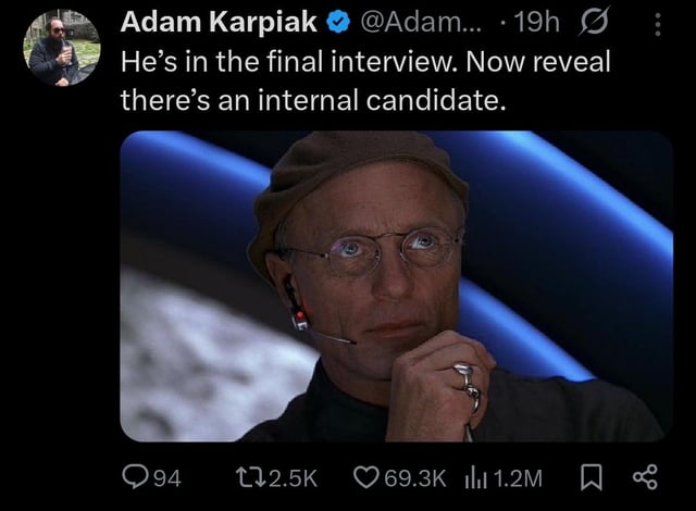 This image is a screenshot of a public X (formerly Twitter) post. The text of the post reads "He's in the final interview. Now reveal there's an internal candidate." Below the text is a still of the character Christof from the 1998 film *The Truman Show*, who is looking contemplatively at an off-screen monitor while resting his chin on his hand. The meme jokes about the common, frustrating hiring practice where companies run full interview processes for external candidates even when they already plan to give the role to an existing internal employee, wasting the time of applicants who have no real chance of being hired.