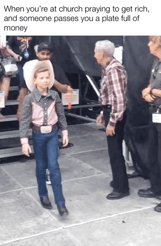 This meme consists of text placed above a photo of viral internet personality Mason Ramsey, known as the Walmart yodeling kid, wearing full cowboy attire including a white cowboy hat, western patterned shirt, jeans, cowboy boots, and a large belt buckle, walking with a deadpan, unreadable, slightly smug expression. The overlaid text reads 'When you're at church praying to get rich, and someone passes you a plate full of money'. The joke relies on situational irony: people pray for financial gain at church, but when a plate full of money (the church collection plate, intended for attendees to donate money to the church rather than take from it) arrives as if answering the prayer, the person is faced with the conflicting expectation to give instead of take the money, which is perfectly reflected by the confused yet slightly scheming expression of the child in the photo.