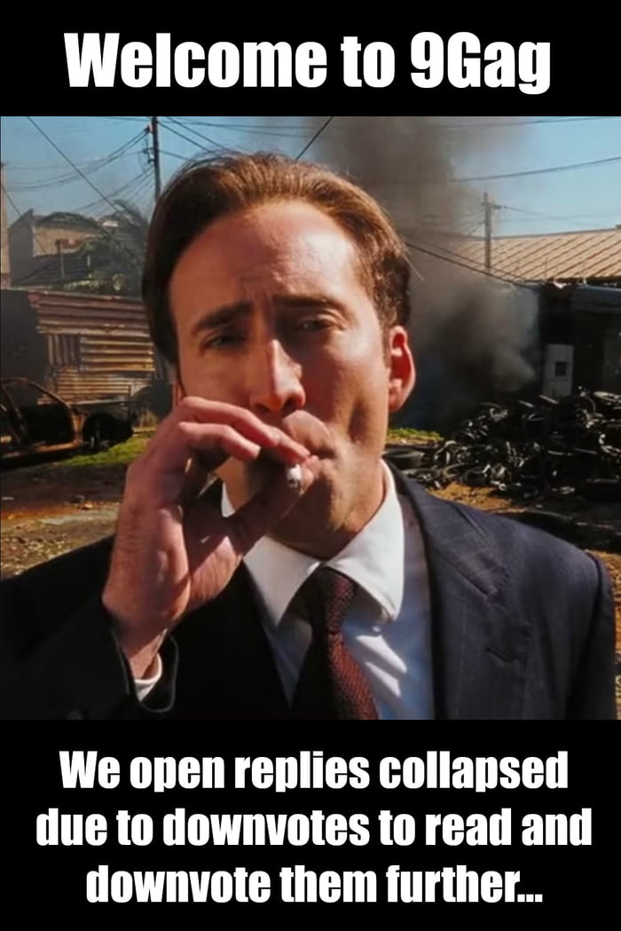 The meme features a photograph of Nicolas Cage dressed in a dark suit, white shirt, and red tie, smoking a cigarette. The background is chaotic, with visible piles of tires, burning debris emitting black smoke, and industrial structures, creating a sense of disorder. The top text reads 'Welcome to 9Gag' in bold white letters, while the bottom text humorously critiques the platform's comment section culture: 'We open replies collapsed due to downvotes to read and downvote them further...'. Nicolas Cage's neutral expression, combined with the chaotic backdrop, sarcastically reflects the often toxic yet engaging nature of 9Gag's user comments.