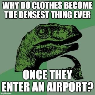 A meme featuring a close-up of a green dinosaur (likely T-Rex) head with a neutral expression, set against a green gradient background. The top text reads 'WHY DO CLOTHES BECOME THE DENSEST THING EVER' and the bottom text continues 'ONCE THEY ENTER AN AIRPORT?'. This humorously references the common frustration among economy and budget airline travelers where luggage, especially clothes, feels significantly heavier or bulkier when packing for travel, often due to strict baggage weight limits.