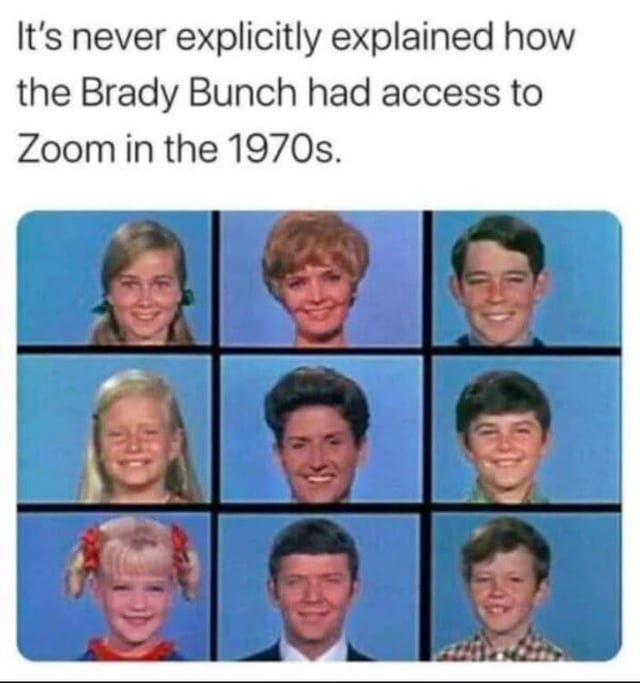 This meme uses the iconic 3x3 grid opening title sequence from the 1969-1974 American sitcom *The Brady Bunch*, which shows every member of the blended Brady family in their own separate framed box against a solid blue background, all smiling at the camera. The text above the image makes a silly anachronistic joke, pointing out that the grid layout is nearly identical to a modern Zoom video call screen, and facetiously claiming it was never explained how the 1970s show had access to Zoom technology decades before the video conferencing platform was invented and became widely used.