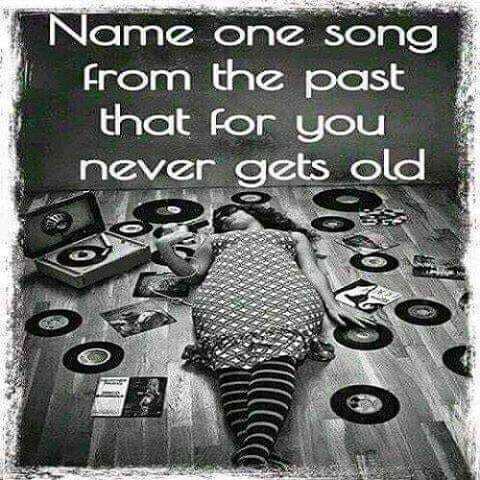 This is an interactive conversational meme that poses a question to viewers, asking them to name one older song that never feels outdated and remains a favorite for them personally. The background is a vintage-styled black-and-white photograph of a relaxed woman lying on a wooden floor, surrounded by scattered vinyl records, album covers, and a portable record player, matching the nostalgic music theme of the prompt.