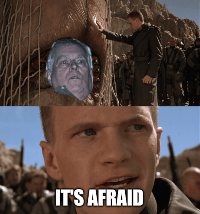 This is a two-panel edited meme derived from a scene in the 1997 sci-fi film *Starship Troopers*. The top panel replaces the face of the captured giant Arachnid bug with the face of a real older man, who has a shocked, fearful expression. In this panel, the character Carl Jenkins (from the original film) is seen touching the bug's head, with a group of soldiers standing in the rocky, desert-like background. The bottom panel is a close-up of Carl Jenkins' face, overlaid with the bold white text "IT'S AFRAID". The humor comes from the absurd face swap, framing the real person as the terrified creature from the original scene, turning the iconic movie moment into a silly reaction image.