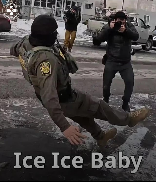 A humorous meme featuring a law enforcement officer in a green uniform with a badge, slipping on ice. The officer is captured mid-fall with one leg lifted high and arms outstretched for balance. In the background, two photographers are visible: one standing near a white vehicle taking photos, and another further back. The ground is wet and icy with patches of snow, indicating a winter setting. At the bottom of the image, large white text reads 'Ice Ice Baby,' a pun referencing the slippery ice and Vanilla Ice's 1990 song of the same name, creating a comedic connection between the officer's slip and the song title.