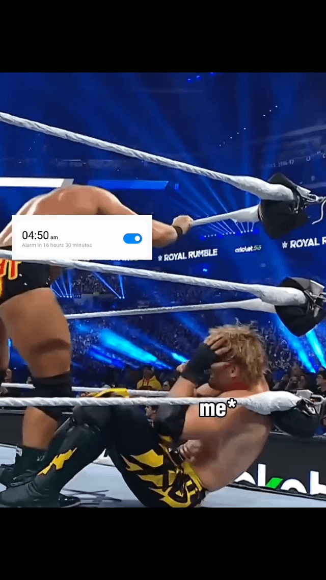This meme uses a screenshot from a WWE Royal Rumble wrestling event to humorously depict the overwhelming dread of an early morning alarm. A wrestler slumped in the ring corner, holding his head in distress, is labeled 'me*' to represent the user's anxious state. An overlay of a mobile phone alarm set for 4:50 AM (with the text 'Alarm in 16 hours 30 minutes') is placed above the scene, symbolizing the impending early wake-up call that the user is already dreading. The background features a live event crowd and visible 'ROYAL RUMBLE' branding, grounding the joke in real professional wrestling footage. The relatable humor stems from comparing the exhaustion and dread of facing an early alarm to being defeated in a wrestling match.
