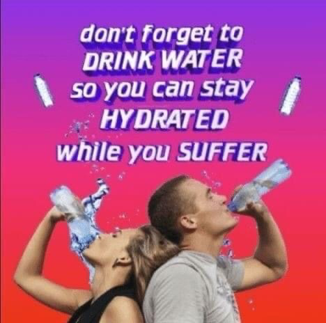 The meme features a bright pink to purple gradient background. At the top, bold white text with a purple drop shadow reads 'don't forget to DRINK WATER so you can stay HYDRATED while you SUFFER'. Below the text, two real people (a blonde woman in a black sleeveless top and a short-haired man in a grey t-shirt) stand back-to-back, each tilting their head back to chug from a plastic water bottle, with water splashing around them. Small water bottle graphics are placed on either side of the upper text. The humor comes from the darkly relatable contrast between the common, wholesome self-care reminder to drink water and the blunt, cynical addendum that hydration is necessary to get through ongoing daily suffering, which resonates with people dealing with stress, work, school, or other difficult circumstances.