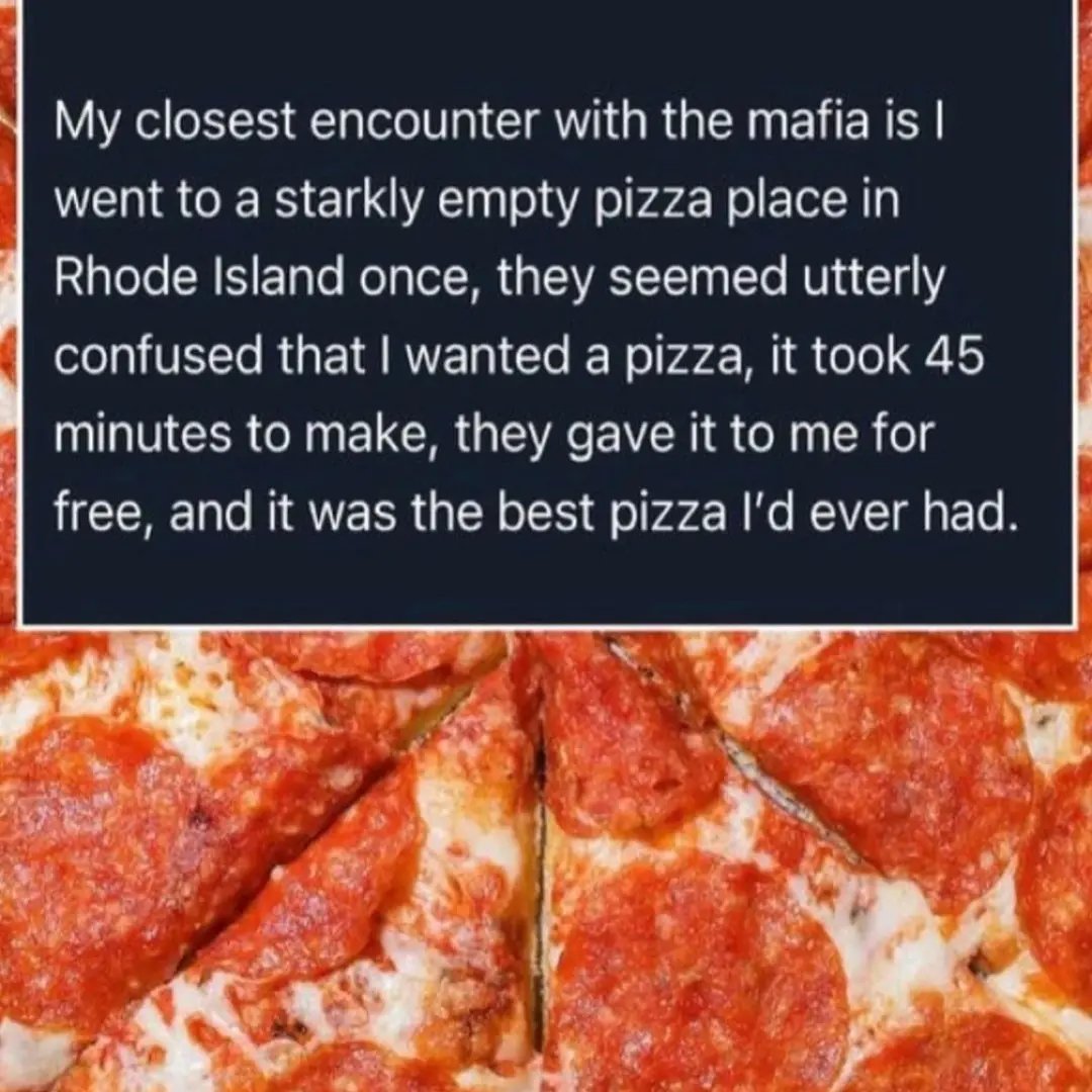 The meme is split into two sections: a top dark blue rectangular box with white sans-serif text, and a bottom section with a close-up photograph of sliced pepperoni pizza covered in melted cheese and overlapping pepperoni slices. The text shares a humorous short anecdote about the poster's claimed closest encounter with the mafia: the poster visited a completely empty pizza restaurant in Rhode Island, where staff appeared confused that a customer actually wanted to order pizza. The order took 45 minutes to prepare, was given to the poster for free, and was described as the best pizza the poster had ever eaten. The implied punchline is that the pizza restaurant was a front business for mafia activities that rarely served actual paying customers.