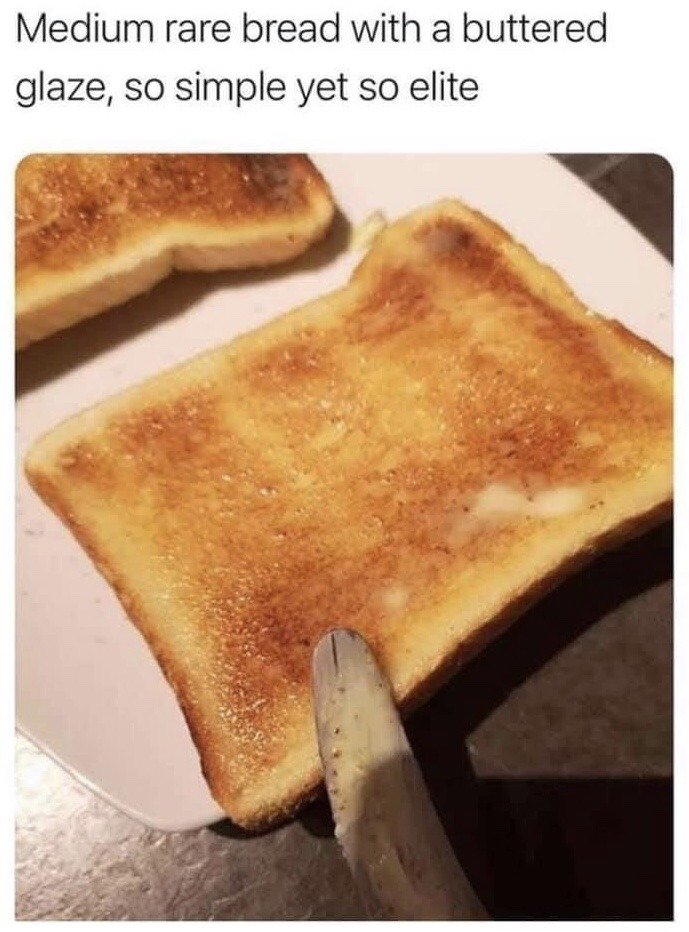The image displays a close-up shot of two slices of lightly toasted buttered white bread resting on a plain white plate, with a butter knife held against the edge of the front slice of toast. Text above the image reads 'Medium rare bread with a buttered glaze, so simple yet so elite', which is a humorous joke that applies the terminology used for describing steak doneness (medium rare) to lightly toasted bread, framing basic buttered toast as an upscale, elite gourmet dish for comedic effect.