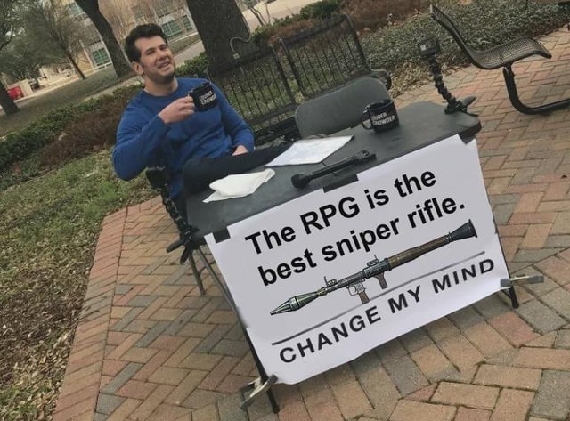 This meme uses the popular 'Change My Mind' template featuring Steven Crowder sitting casually at an outdoor table holding a mug. The custom sign attached to the table reads 'The RPG is the best sniper rifle. CHANGE MY MIND' paired with an illustration of an RPG rocket launcher. The joke references a common humorous trend in the Battlefield series (and other first-person shooter games) where players intentionally use the anti-vehicle RPG explosive weapon to make long-distance kills on enemy players instead of using dedicated sniper rifles, a playstyle that is often seen as silly, impressive, or overpowered depending on the game's balance.