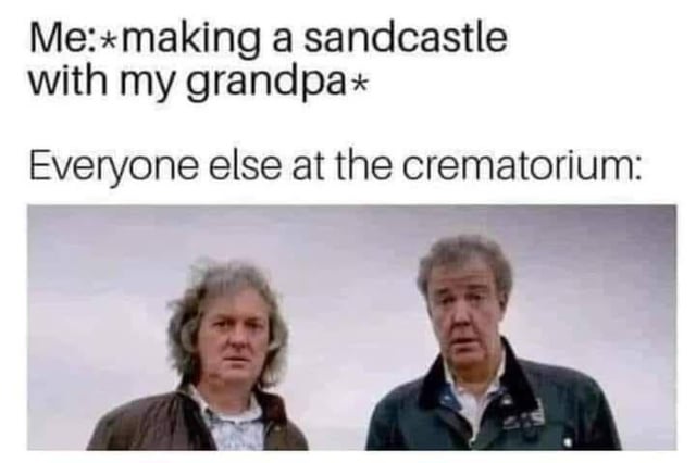 The meme consists of two text sections above a photograph. The top text reads 'Me:*making a sandcastle with my grandpa*' and the middle text reads 'Everyone else at the crematorium:'. Below is a photo of two older men with confused, concerned expressions, likely reacting to the absurd scenario. The humor arises from the darkly comedic contrast between the innocent activity (making a sandcastle) and the grim location (crematorium), implying the grandpa is deceased and the 'me' is interacting with his ghost, which others find confusing.