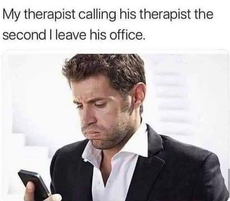 This is a relatable humor meme featuring top text that reads 'My therapist calling his therapist the second I leave his office.' Below the text is a photo of actor John Krasinski wearing a dark suit and white collared shirt, holding a smartphone and looking down at it with a distressed, overwhelmed, exhausted frown. The joke leans into the relatable, self-deprecating idea that the poster's personal problems are so chaotic, severe, or emotionally heavy that their professional therapist is left traumatized enough to need their own therapy appointment right after their session ends.