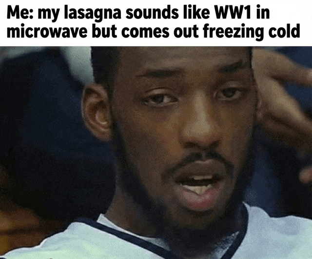 A meme featuring a screenshot of a real person with a confused and perplexed expression. The top text reads: 'Me: my lasagna sounds like WW1 in microwave but comes out freezing cold'. The humor arises from the夸张 comparison of the microwave's loud, chaotic noise (likened to World War 1) to the underwhelming result of the lasagna being freezing cold, highlighting a relatable everyday frustration with microwaving food that fails to heat properly despite making significant noise.