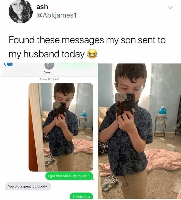 This image is a screenshot of a post from X (formerly Twitter) by user ash (@Abkjames1). The post displays a text message exchange between the poster's young son and her husband. The son sends two mirror selfies showing himself wearing a dark blue floral short-sleeve button-up shirt and khaki pants, holding a smartphone to take the photo. He accompanies the selfies with a message stating 'I got dressed all by my self.' His father replies encouragingly: 'You did a great job buddy.', to which the son responds 'Thanks bud'. The poster adds a laughing crying emoji and notes that she found these messages her son sent to her husband that day, finding the interaction funny and endearing.