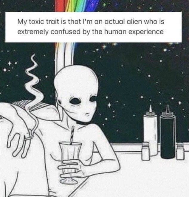 This is a single-panel illustrated meme featuring a line-drawn classic grey alien sitting at a diner-style counter. The alien holds a milkshake with a straw, has a blank, deadpan, confused expression, and rests one arm on the back of the booth seat. The background visible through the window behind the counter is outer space dotted with stars, with a rainbow arc at the top of the window. A text box at the top of the image reads: 'My toxic trait is that I'm an actual alien who is extremely confused by the human experience'. The joke humorously frames feelings of social awkwardness, disorientation with common human social norms, and feeling out of place as being a literal alien lost on Earth, positioned as a lighthearted 'toxic trait' for comedic effect.