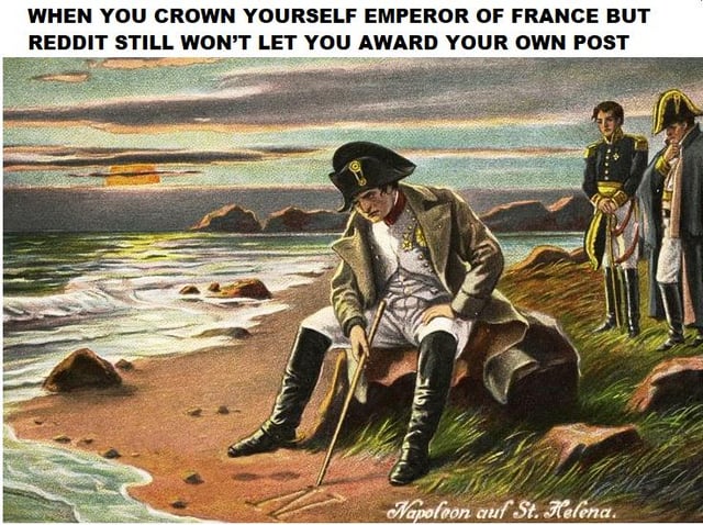 This meme uses a classic historical illustration depicting a dejected Napoleon Bonaparte during his exile on the island of Saint Helena, sitting on a rock by the beach looking down somberly while two uniformed officers stand behind him. Text added at the top of the image makes a humorous, anachronistic joke: 'WHEN YOU CROWN YOURSELF EMPEROR OF FRANCE BUT REDDIT STILL WON'T LET YOU AWARD YOUR OWN POST', drawing a parallel between Napoleon's real-life defeat and exile and the small, frustrating restriction on Reddit that prevents users from giving awards to their own posts. The original illustration's German caption at the bottom reads 'Napoleon auf St. Helena', meaning 'Napoleon on St. Helena'.