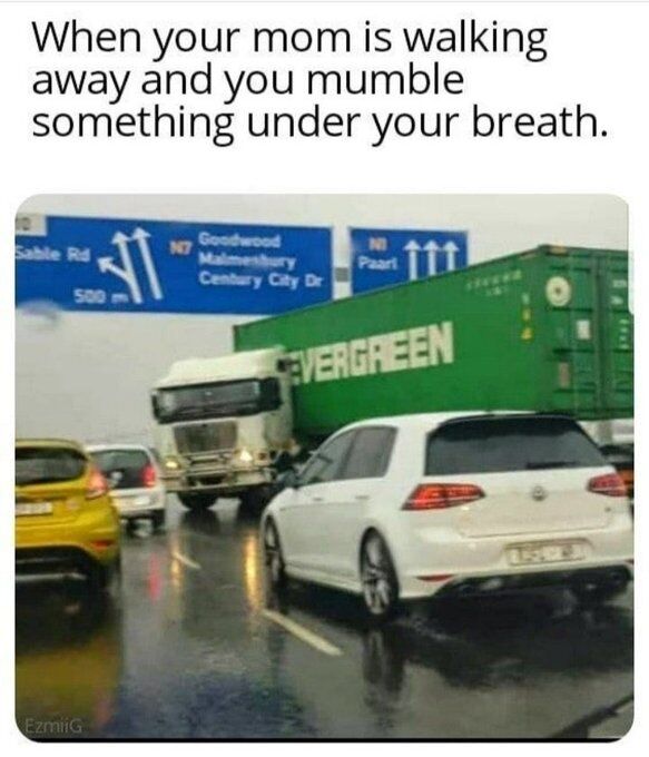This is a relatable humorous meme. The top of the image features text that reads "When your mom is walking away and you mumble something under your breath." Below the text is a photograph of a rainy, wet highway with stopped passenger cars, and a large Evergreen branded freight truck appears to be abruptly veering into the lane of stopped traffic. The meme draws a comedic parallel between the truck's sudden, unexpected approach and the common childhood experience of a parent immediately turning to confront you after you quietly mutter a complaint under your breath when you think they have already walked away.