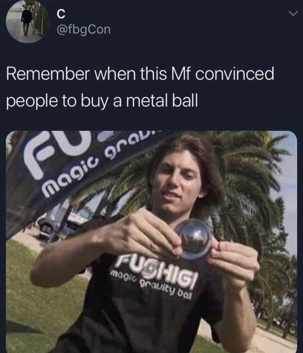 This is a screenshot of a social media post from X (formerly Twitter). The post text reads 'Remember when this Mf convinced people to buy a metal ball', paired with a still image from a Fushigi magic gravity ball infomercial. The infomercial host wears a branded Fushigi shirt, holds up the shiny metal Fushigi ball, which was infamously marketed as a special 'magic gravity ball' novelty item in 2000s/early 2010s infomercials, despite being a standard overpriced weighted metal ball. The meme jokes about the absurdity of the successful marketing campaign that convinced many consumers to purchase the mundane object.
