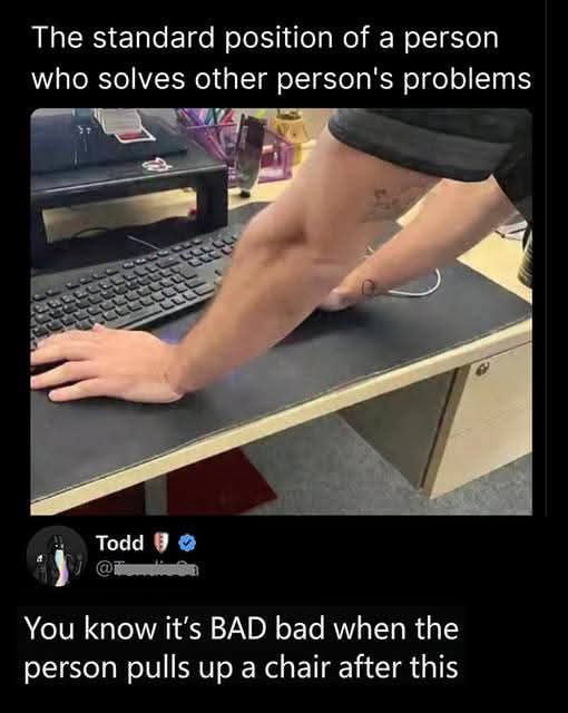This meme features a photograph of a person leaning over an office desk, with one arm stretched out to rest a hand on a keyboard and the other arm propped on the desk surface in an awkward, leaned-over posture. The text overlay at the top reads 'The standard position of a person who solves other person's problems'. Below the photograph is a comment from X (Twitter) user Todd that states 'You know it's BAD bad when the person pulls up a chair after this'. The joke plays on the common relatable experience of people, often tech support or knowledgeable coworkers, first leaning over someone else's desk to quickly fix a minor issue, only sitting down fully if the problem is much more severe and will take a long time to resolve.