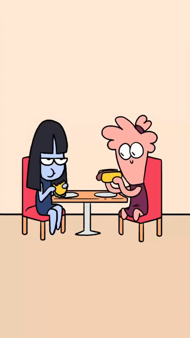 An illustration depicting two animated characters sitting at a small round table with red chairs. The character on the left is blue-skinned with long black hair, wearing a dark blue outfit, and holds a yellow burger with a calm, slightly indifferent expression. The character on the right is pink-skinned with a flower-like head shape, wearing a dark purple outfit, and holds a yellow hot dog with wide, excited eyes and an enthusiastic expression. The background is a plain beige color, keeping focus on the characters and their meal.