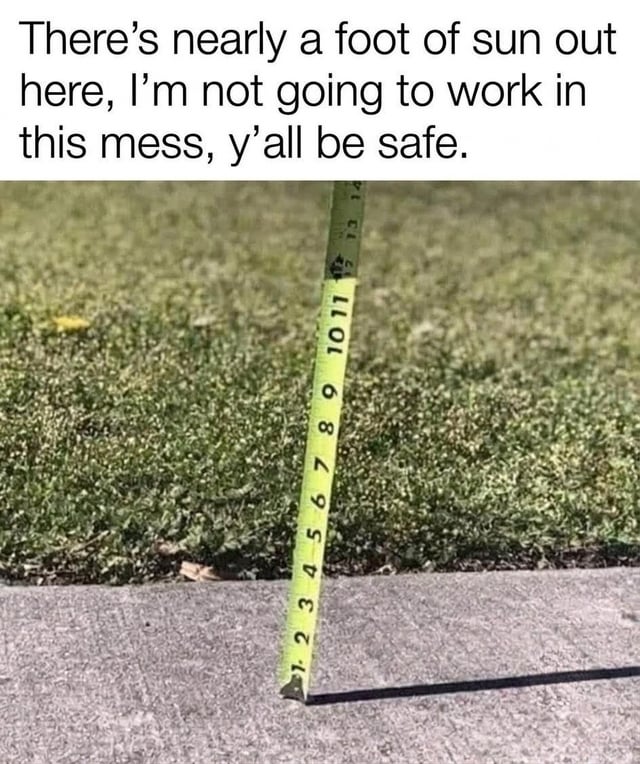 This meme features two core sections: a top text block that reads 'There's nearly a foot of sun out here, I'm not going to work in this mess, y'all be safe,' paired with a photograph below. The photo shows a yellow measuring tape stood upright on a concrete sidewalk, casting a roughly 12-inch (1 foot) long shadow onto the pavement, with a patch of green grass visible in the background. The core joke is a parody of the common practice of using measured heavy snowfall (counted by the foot) as a valid excuse to skip work, absurdly applying the same measurement logic to the length of a sun shadow to frame nice sunny weather as a reason to avoid going to work, which is reinforced by the title asking if the poster is a sunflower that would be negatively impacted by heavy sunshine.