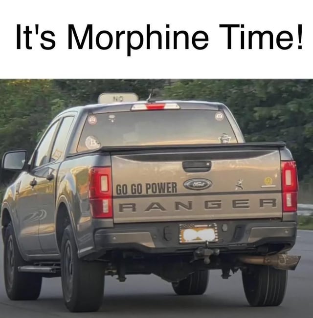 The meme consists of two main elements: a bold text overlay at the top reading 'It's Morphine Time!' and a rear-view photograph of a silver Ford Ranger pickup truck. The truck's tailgate features custom text that modifies the iconic 'Go Go Power Rangers' catchphrase from the Power Rangers franchise to 'GO GO POWER RANGER,' directly referencing the popular series. The humor arises from a pun on the word 'Morphine' (a pain-relieving medication) replacing 'Morphin' from the Power Rangers' 'It's Morphin Time!' catchphrase, creating an absurd and comedic contrast between the medical drug and the action-oriented pop culture reference. The truck is shown driving on a road with greenery in the background, and the Ford logo is visible on the tailgate.