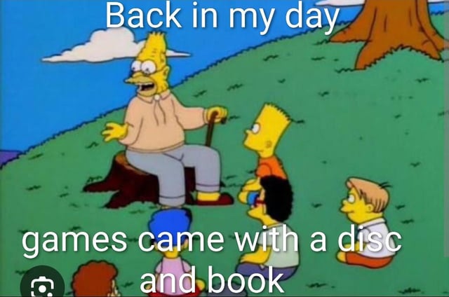 This meme uses a classic scene from the animated series The Simpsons. Grandpa Abraham Simpson is seated on a tree stump in a grassy outdoor area, holding a cane and gesturing as he speaks to a group of attentive children, including Bart Simpson, who are sitting on the grass in front of him. Overlaid text at the top reads 'Back in my day', while text at the bottom states 'games came with a disc and book'. The meme jokes about generational nostalgia, referencing the fact that older physical video game releases came with optical discs and printed instruction manuals, unlike most modern digital-only game releases that have no accompanying physical materials.