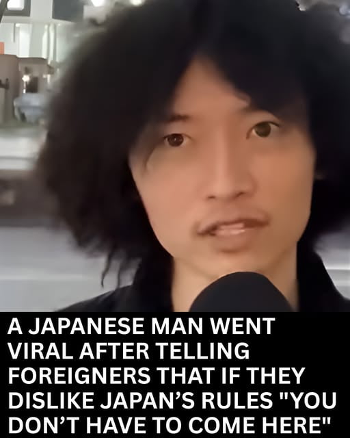 The image features a Japanese man holding a microphone, likely in an interview or public statement setting. Below him, a bold text overlay reads: 'A JAPANESE MAN WENT VIRAL AFTER TELLING FOREIGNERS THAT IF THEY DISLIKE JAPAN’S RULES "YOU DON’T HAVE TO COME HERE"'. The original title 'I mean... he's right' suggests agreement with the man's statement, framing it as a straightforward or justified opinion.