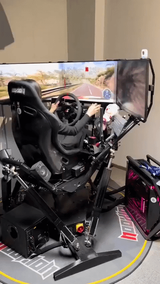 An image depicting a person seated in an elaborate racing simulator setup, featuring a specialized racing seat, a steering wheel controller, and multiple large monitors displaying a racing game environment. The scene humorously embodies the concept from the original title: winning the jackpot but keeping it secret, with the luxurious racing simulator serving as an implicit 'sign' of newfound wealth that betrays the secret.