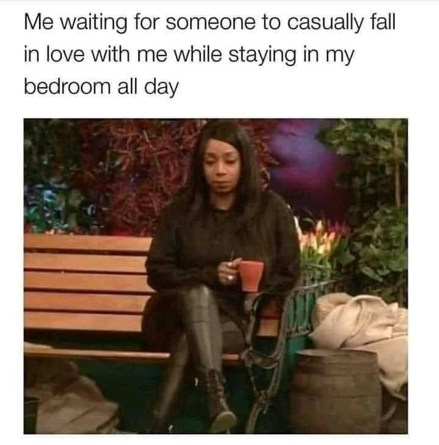 This meme consists of two parts: top text describing a relatable dating sentiment, and a lower reaction image of Tiffany Haddish sitting on a wooden park bench holding a red mug, looking blank, bored, and passively waiting. The joke highlights the common contradictory desire for romantic connection without putting in the effort to go out and meet potential partners, instead hoping romance will arrive spontaneously while the person stays isolated at home.