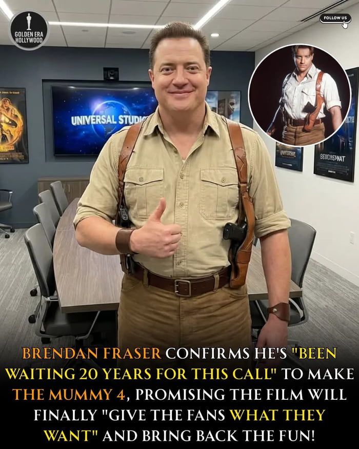 A photograph of actor Brendan Fraser standing in a modern conference room, dressed in a beige button-up shirt, brown pants, and a leather holster rig resembling his iconic role as Rick O'Connell from 'The Mummy' franchise. He is positioned in front of a wooden conference table with gray office chairs, giving a thumbs-up gesture with his right hand. In the top right corner, there is a circular inset image of Fraser in his original 'The Mummy' costume, featuring a white shirt with suspenders. The background includes a large screen displaying 'UNIVERSAL STUDIOS' and several movie posters on the walls. A bold yellow and white text overlay at the bottom announces Fraser's confirmation of 'The Mummy 4,' stating he 'been waiting 20 years for this call' and promising to 'give the fans what they want.'