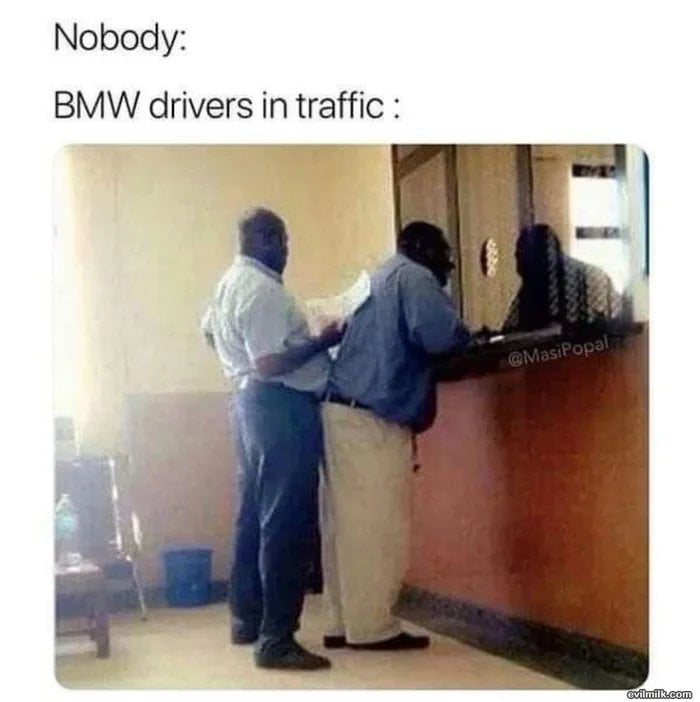 A meme featuring two lines of text at the top: 'Nobody:' followed by 'BMW drivers in traffic :'. Below the text is a photograph of three individuals leaning over a counter, appearing to crowd or push forward. The meme humorously uses this image to satirize the stereotype that BMW drivers are impatient or pushy in traffic situations by implying they exhibit similar behavior when interacting with a counter.