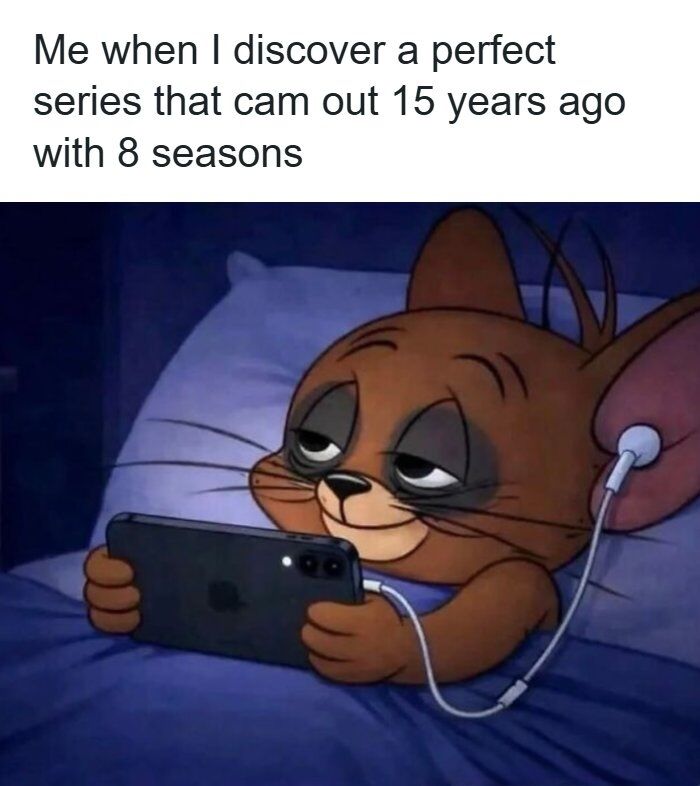 This meme consists of two parts: top text that reads 'Me when I discover a perfect series that cam [typo for came] out 15 years ago with 8 seasons', followed by an edited image of Jerry the mouse from *Tom and Jerry*. Jerry is lying in bed at night, holding an iPhone, wearing wired earbuds, with heavy dark circles under his half-lidded eyes and a small content smile, indicating he has stayed up all night binge-watching the newly discovered series. The joke humorously captures the relatable experience of finding a high-quality, long-running older show and losing sleep to binge through all its episodes.