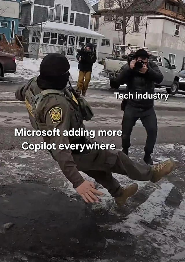 A meme image featuring a real-life photograph of a uniformed individual (resembling law enforcement) slipping and falling backward on an icy street. To the right, another person dressed in dark clothing is taking photographs, with the text overlay 'Tech industry' above them. The falling individual has the text overlay 'Microsoft adding more Copilot everywhere' across their body. The image humorously satirizes Microsoft's aggressive integration of its Copilot AI tool across products, portraying the tech industry as reacting to this chaos by documenting the 'fall' (metaphorical stumble) of Microsoft's overreach.