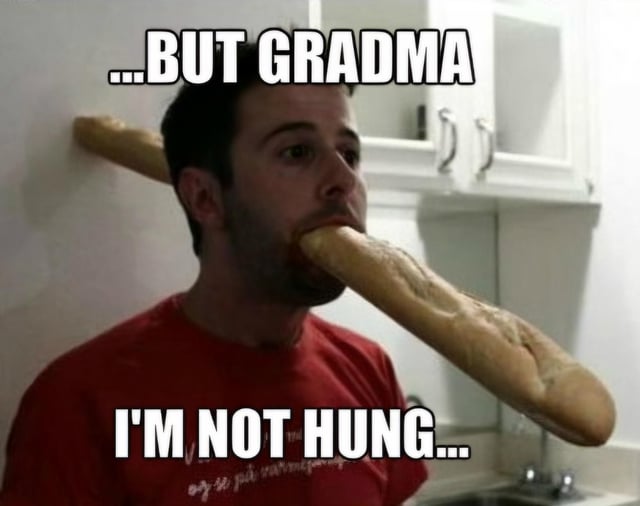 A meme image featuring a real man wearing a red shirt standing in a kitchen. He has a long baguette held horizontally in his mouth, with two text overlays: the top text reads '...BUT GRANDMA' and the bottom text reads 'I'M NOT HUNG...'. The humor stems from the irony of the man physically holding a baguette (a food item) while claiming he is not hungry, likely in response to a grandmother offering him food, creating a relatable and funny scenario about overbearing but loving family members offering food.