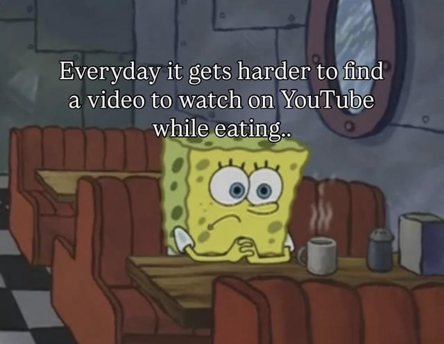 This is a relatable meme using a screenshot from the animated series SpongeBob SquarePants. SpongeBob is shown sitting in a Krusty Krab booth with a dejected, frustrated expression, hands clasped under his chin. Overlaid text on the image reads 'Everyday it gets harder to find a video to watch on YouTube while eating..', which humorously expresses the common shared frustration of struggling to find suitable, interesting YouTube content to view during meal times, often attributed to poor platform algorithm recommendations.