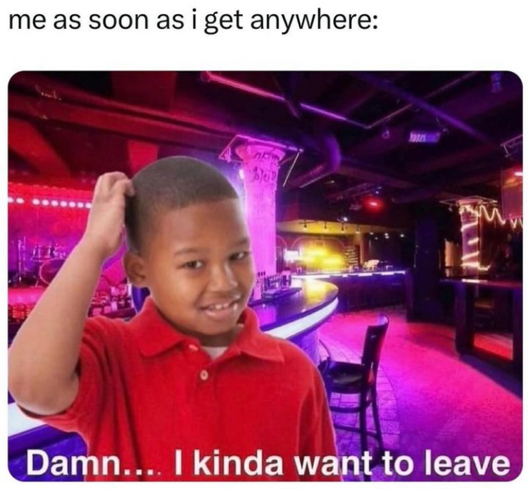This is a humorous relatable meme. The top of the meme features setup text that reads 'me as soon as i get anywhere:'. Below this text is an edited composite image: a widely used reaction photo of a young Black boy wearing a red polo shirt, scratching the back of his head with an awkward, slightly confused smile, is superimposed over the background of a dim, neon-lit empty bar/club with purple and red ambient lighting. Punchline text at the bottom of the image reads 'Damn.... I kinda want to leave'. The meme jokes about the common introvert or socially anxious experience of immediately feeling the urge to leave a social venue right after arriving, even if the location looks appealing.