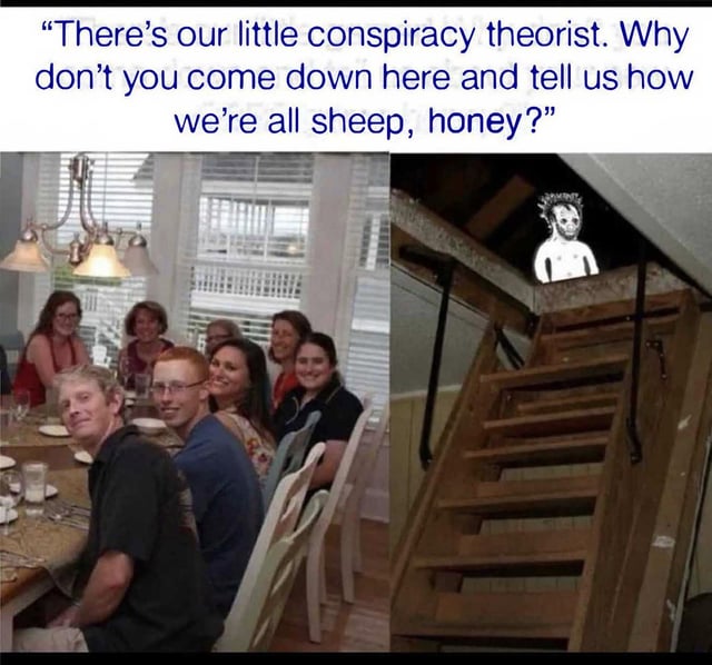 This is a two-panel humorous meme. The top overlaid text reads: “There’s our little conspiracy theorist. Why don’t you come down here and tell us how we’re all sheep, honey?”. The left panel shows a group of smiling, ordinary middle-class family members seated around a dining room table looking upwards as if calling to someone on a higher level. The right panel shows a pull-down wooden attic staircase, with a deranged-looking cartoon conspiracy theorist character peeking out from the dark attic opening at the top. The joke plays on the stereotype of people who believe fringe conspiracy theories often isolate themselves from mainstream society (hiding in the attic in this case) and dismiss regular people as unthinking "sheep", while their family playfully teases them to come down and explain their views.