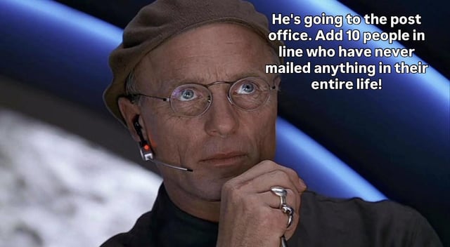 This meme features a still of the character Christof, the mastermind creator from the 1998 film *The Truman Show*, who is shown resting his chin on his hand, looking upward with a scheming, plotting expression. White text is overlaid on the right side of the image, reading: 'He's going to the post office. Add 10 people in line who have never mailed anything in their entire life!'. The joke frames the universe or fate as the scheming Christof, intentionally creating frustrating, unnecessary delays for a person attempting to complete a simple errand, referencing the common relatable annoyance of slow, crowded lines at post offices where other patrons appear unfamiliar with the mailing process.