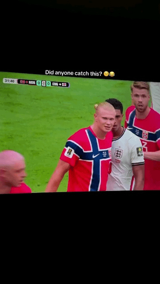 This meme features a screenshot of a live broadcast of a men's international football match between Norway (NOR) and England (ENG), with the score tied at 0-0 at the 31:40 mark of the match. The core joke comes from a forced perspective optical illusion: Norwegian star striker Erling Haaland, wearing Norway's red national jersey, stands so close in front of an opposing England player in a white jersey that Haaland's blond topknot hairstyle appears to be on the England player's head. Above the screenshot, text reads "Did anyone catch this? 😂😂" pointing out this visual gag. The meme is titled "Naughtingham", a double pun: first, it replaces the first syllable of the English city "Nottingham" with "naught" (meaning zero), referencing the 0-0 scoreline, and second, it nods to the silly, playful visual gag.