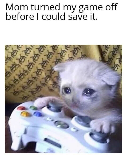 A meme featuring a small, light-colored kitten with large, teary eyes gripping a white game controller (resembling an Xbox controller). Above the image is the text: 'Mom turned my game off before I could save it.' The kitten's sad expression humorously personifies the frustration of losing unsaved progress in a video game, creating a relatable and emotional reaction meme.