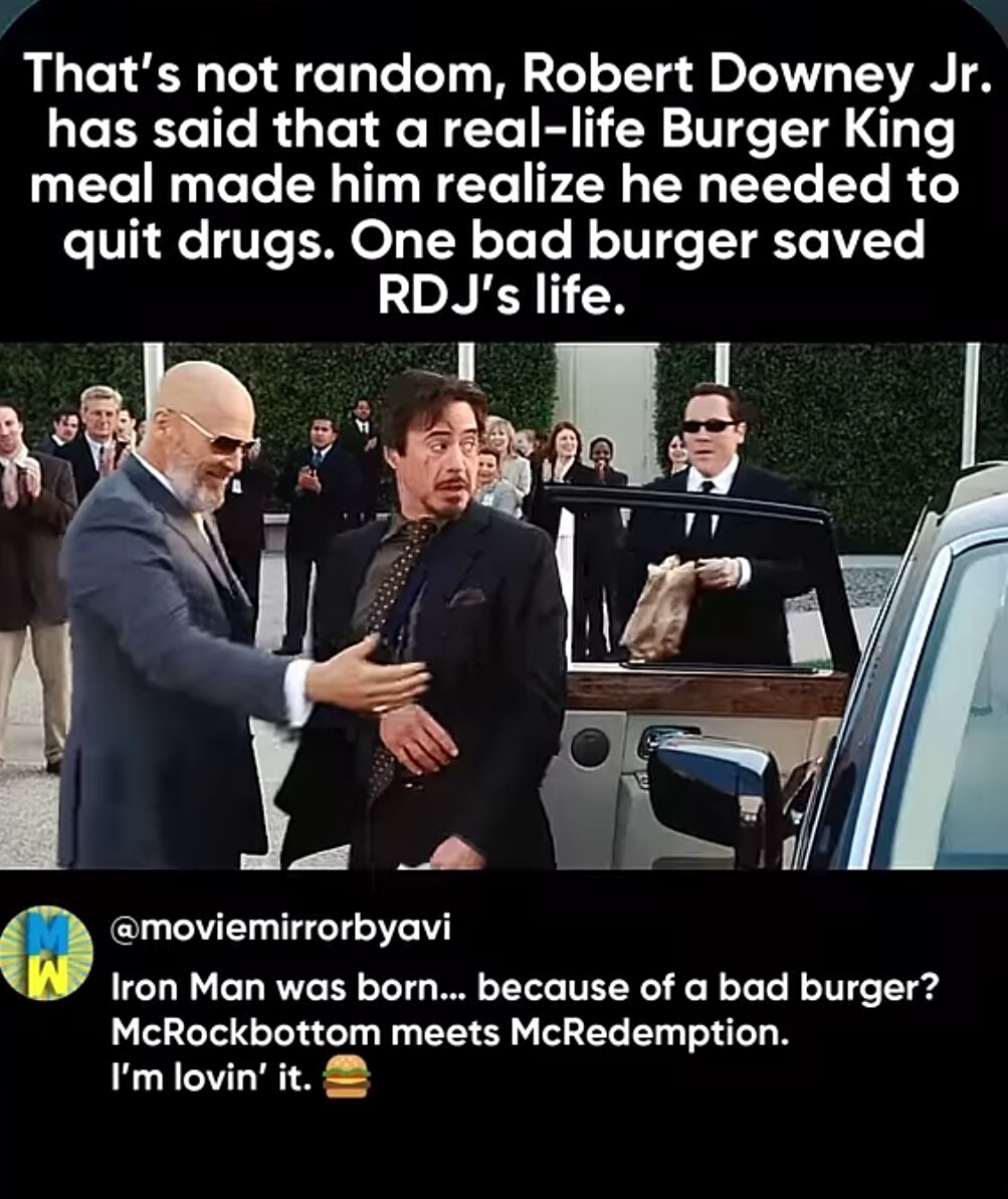 The meme features a movie screenshot of Robert Downey Jr. (RDJ) in a dark suit, surrounded by formally dressed people and a crowd. The top text explains RDJ's real-life anecdote: a bad Burger King meal prompted his decision to quit drugs, with the key line 'One bad burger saved RDJ's life.' The bottom text from @moviemirrorbyavi adds humor: 'Iron Man was born... because of a bad burger? McRockbottom meets McRedemption. I'm lovin' it.' (a play on McDonald's slogans, combining 'rock bottom' and 'redemption').