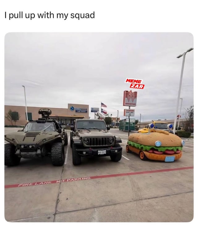 A meme depicting a parking lot scene with three contrasting vehicles parked in a fire lane marked 'FIRE LANE NO PARKING'. From left to right: a rugged, military-style vehicle with a mounted camera and large tires; a green Jeep SUV; and a whimsical hamburger-shaped car with lettuce, tomato, and bun details, including a blue 'headlight' and orange wheels. The background features a Walmart sign, other storefronts, an American flag, and a cloudy sky. The top text reads 'I pull up with my squad,' humorously framing the diverse, absurd collection of vehicles as a 'squad' to highlight the theme of diversity in a playful way. A red 'MEME ZAR' watermark is visible in the top right corner.