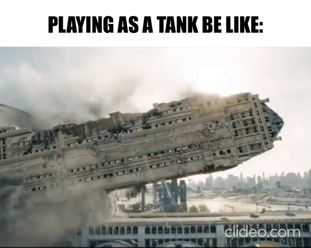 This meme features bold text at the top that reads 'PLAYING AS A TANK BE LIKE:', paired with a visual of a massive, heavily damaged sci-fi capital ship that is still standing and largely intact despite extreme destruction and surrounding smoke. The joke draws a humorous parallel between the tank class in multiplayer video games, which is purpose-built to absorb extremely high amounts of incoming damage to protect teammates while remaining operational, and the ruined but still functional ship depicted in the scene.
