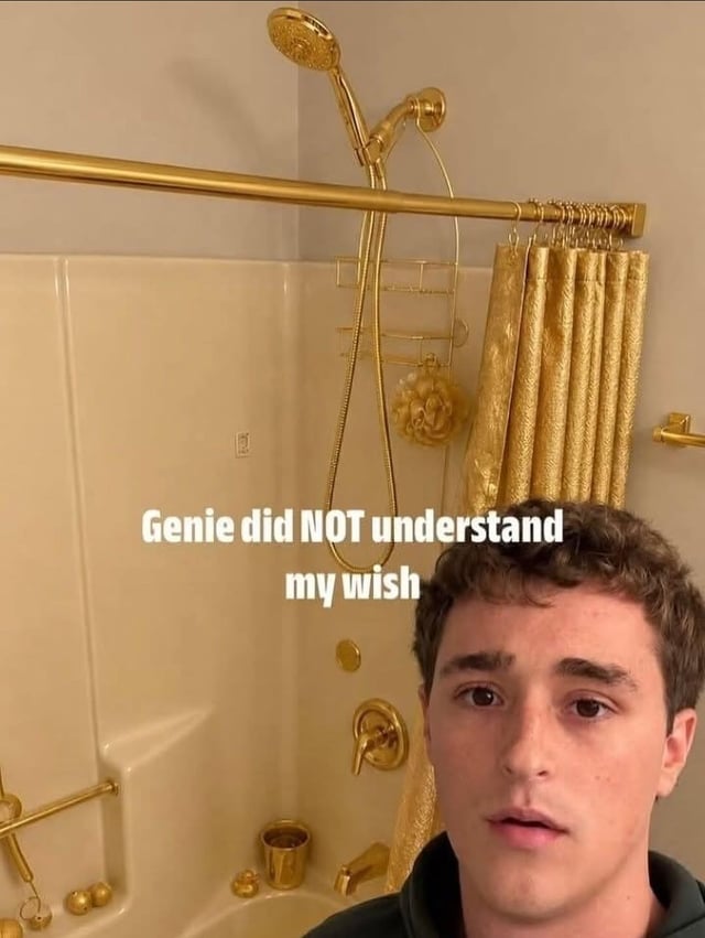 The meme features a young man with a confused, disappointed expression standing in front of a bathroom shower where every fixture, including the shower head, curtain rod, shower curtain, control knobs, storage caddy, and small bathroom accessories are completely gold-colored. Overlaid white text on the image reads 'Genie did NOT understand my wish'. The core humor comes from a pun on the slang term 'golden shower': the poster presumably wished for a 'golden shower' referring to the related sexual act, but the genie misinterpreted the request literally, turning all parts of his shower setup gold instead.